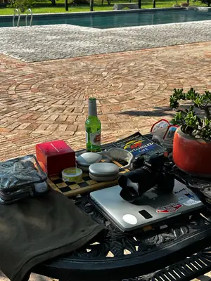 Una mesa con cámara y libros al borde de la piscina